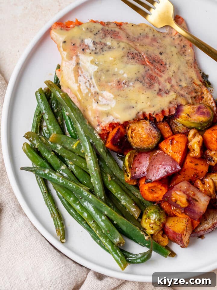 lemon butter green beans, roasted vegetables and maple mustard salmon on a plate