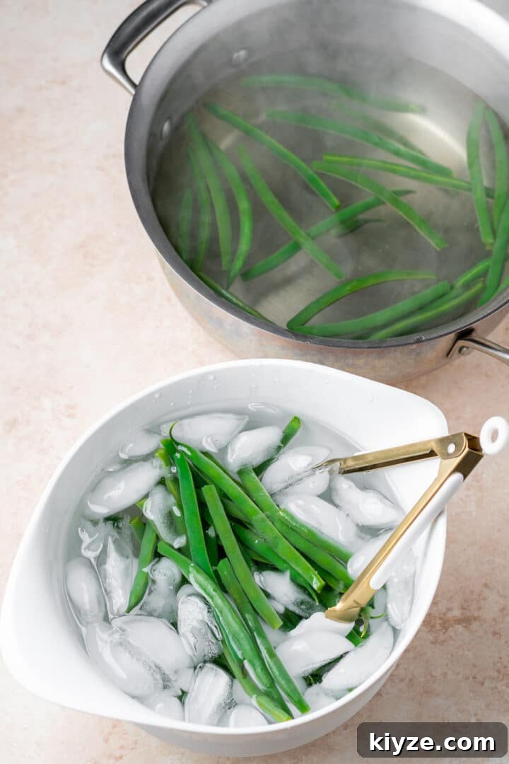 green beans in a white bowl of ice water