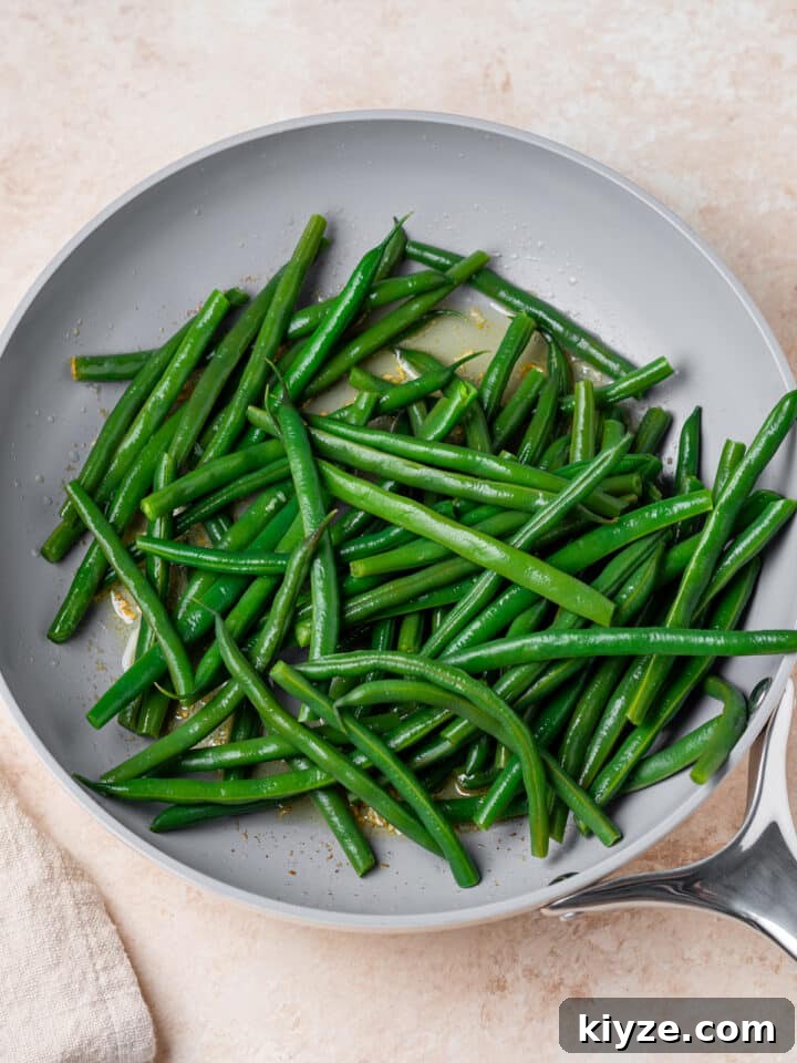 cooked green beans added to the garlic butter