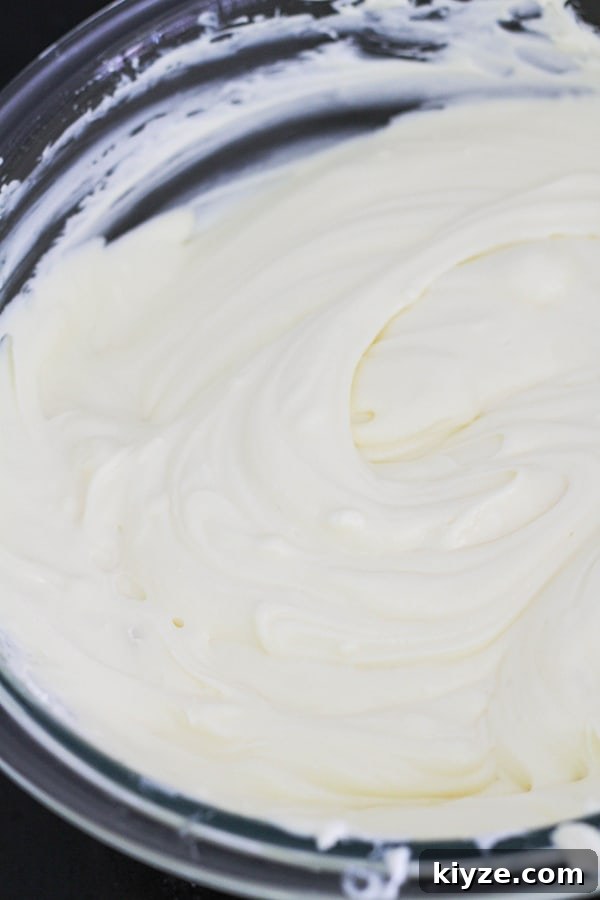 No-Bake Marble Cheesecake Recipe: Creamy Swirl No-Bake Cake 9 cheesecake mixture in a glass bowl.