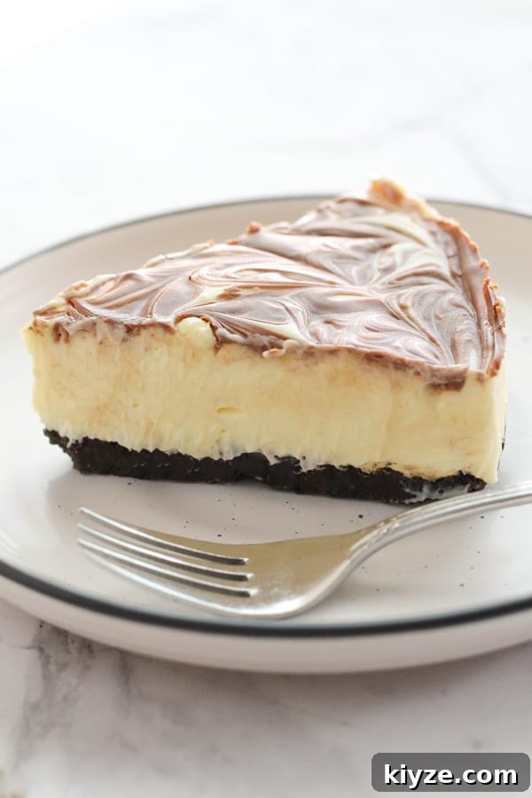 No-Bake Marble Cheesecake Recipe: Creamy Swirl No-Bake Cake 11 a slice of marble cheesecake with a fork on the plate.