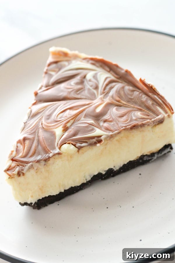 No-Bake Marble Cheesecake Recipe: Creamy Swirl No-Bake Cake 12 a slice of marble cheesecake on the plate.