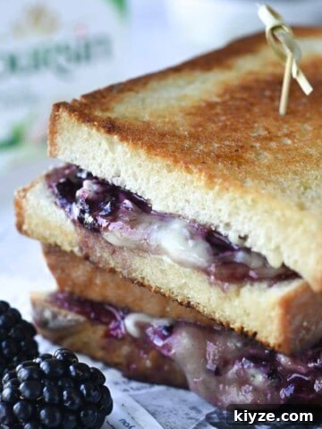 Cloe-up of blackberry grilled cheese with blackberries in the foreground.