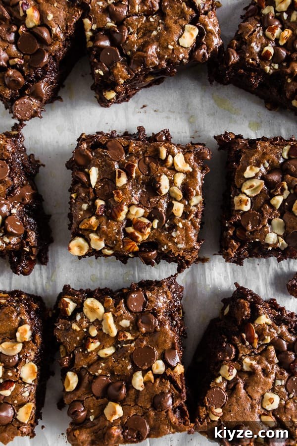Hazelnut Buckwheat Brownies Recipe with Crispy Edges 2 Hazelnut Buckwheat Brownies cut on parchment paper.