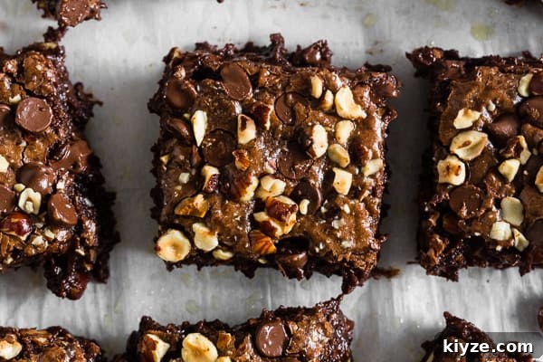 Hazelnut Buckwheat Brownies Recipe with Crispy Edges 4 Hazelnut Buckwheat Brownies topped with nuts.