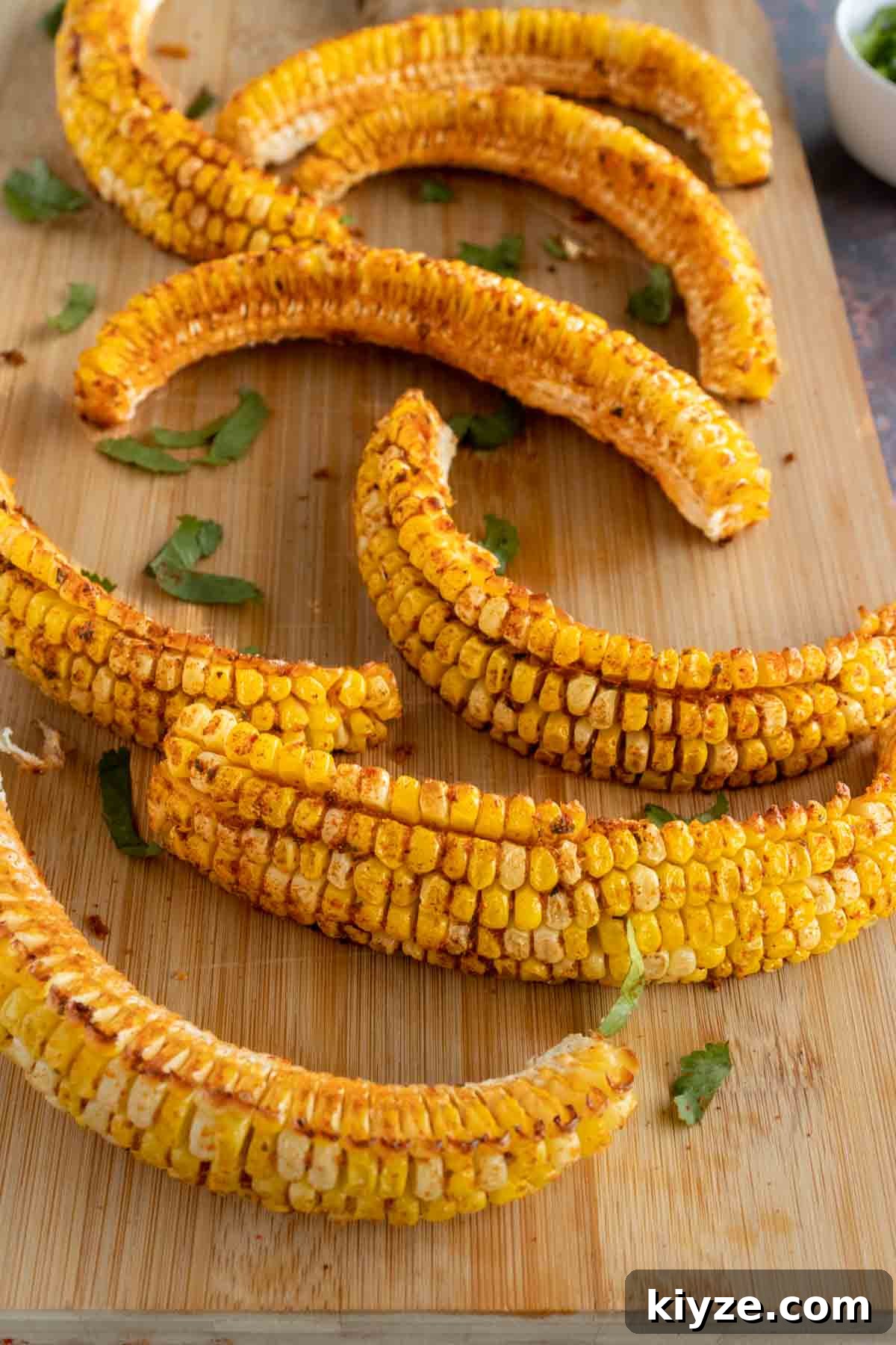 Crispy Corn Ribs Recipe (Corn Riblets) 2 Corn ribs on a cutting board.