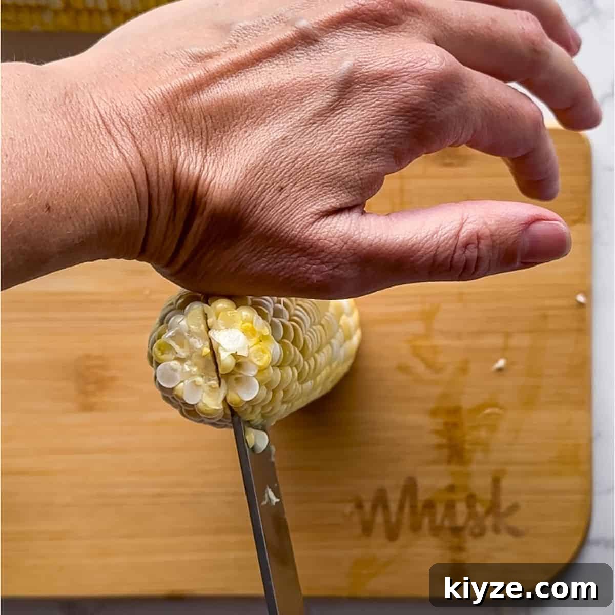 Crispy Corn Ribs Recipe (Corn Riblets) 4 Cutting the corn in half.