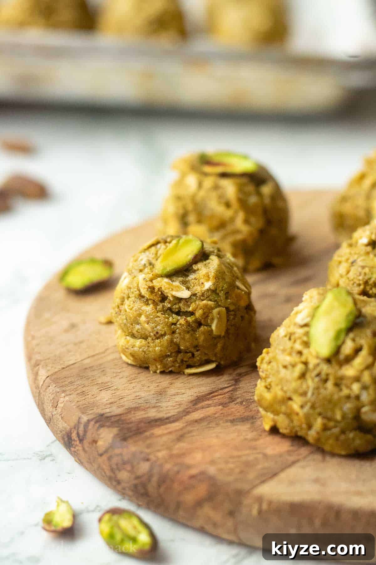 Pistachio protein ball on wooden board.