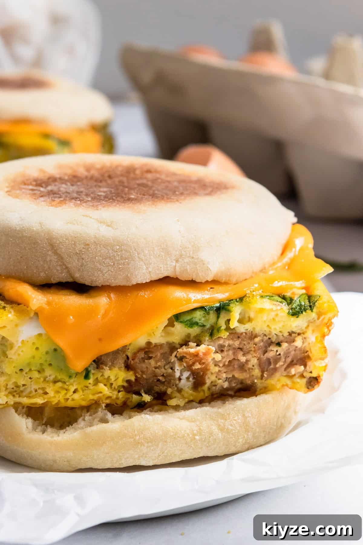 Freezer-Friendly Sausage McMuffin with Spinach Recipe 2 Sausage mcmuffin with spinach and melted cheese.