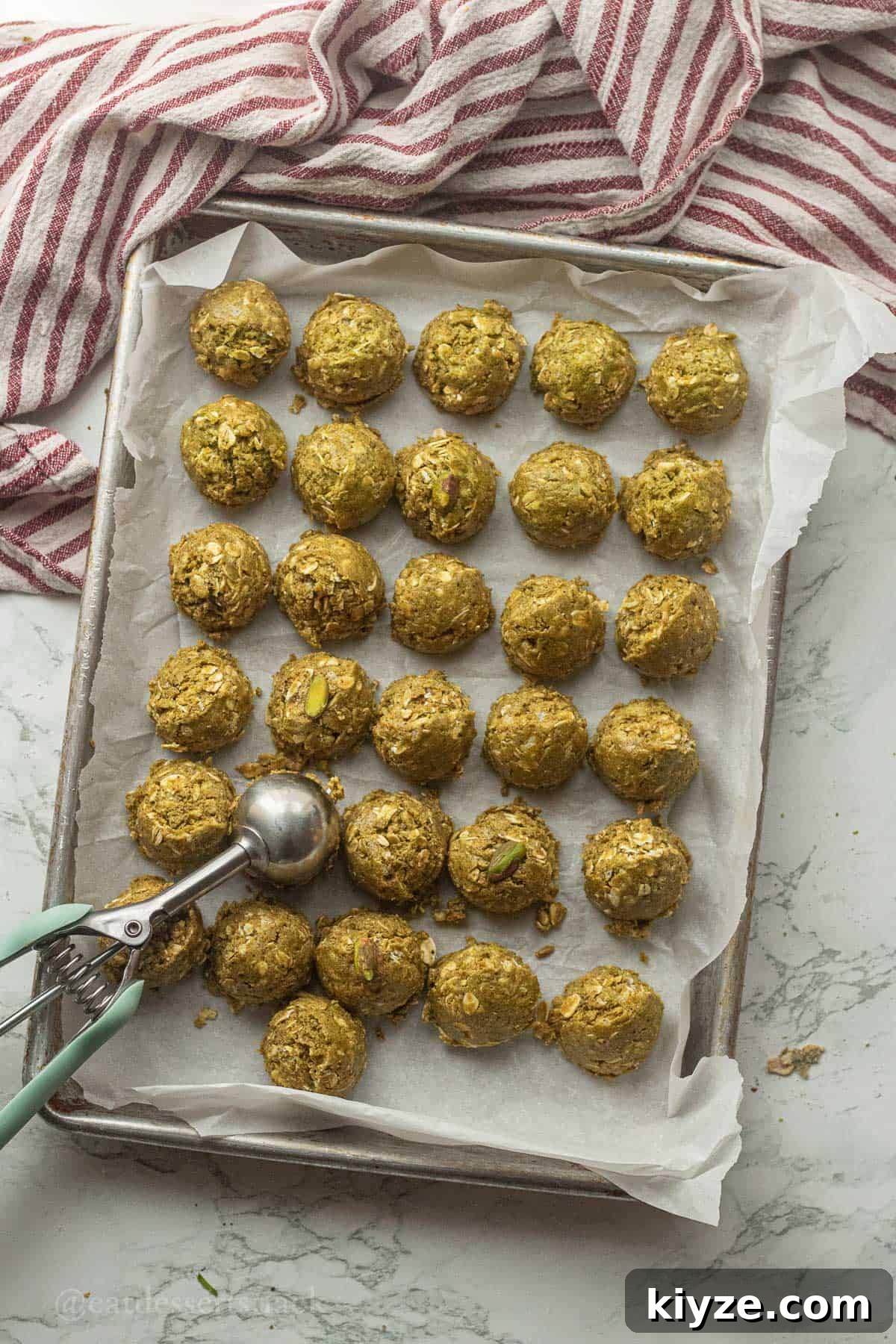 Pistachio protein balls on metal pan.