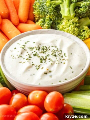 Bowl of ranch cottage cheese dip on tray of veggies.