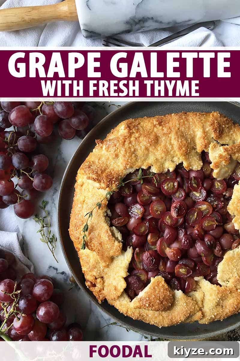 Grape Galette: Turn Fresh Grapes into a Rustic Dessert 2 Vertical top-down image of a whole galette with grapes and thyme, next to more fruit and a rolling pin, with text on the top and bottom of the image.