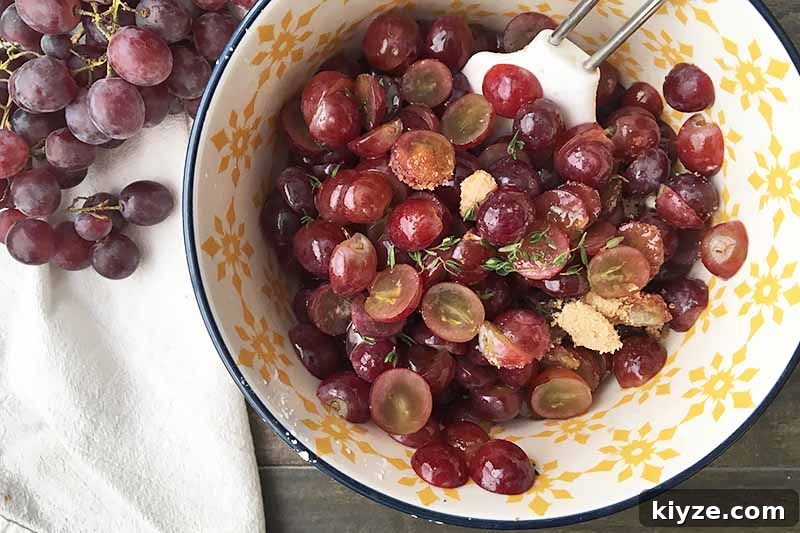 Grape Galette: Turn Fresh Grapes into a Rustic Dessert 11 Horizontal image of a bowl with a fresh grape, thyme, and sugar mixture.