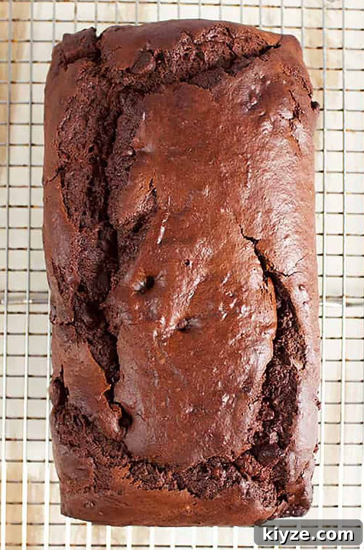 Chocolate banana bread on a wire cooling rack.