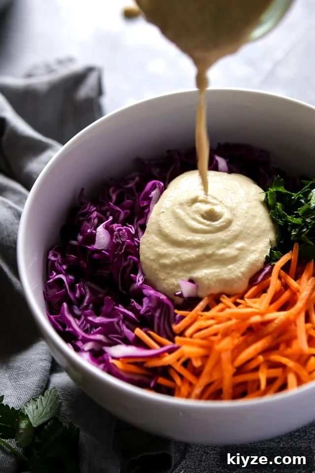 Adding Vegan Mayo to a big bowl full of Coleslaw Salad