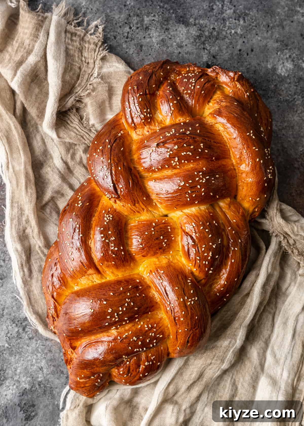 Classic Fluffy Challah Recipe for Braiding and Baking 15 overhead: finished challah bread on tea towel