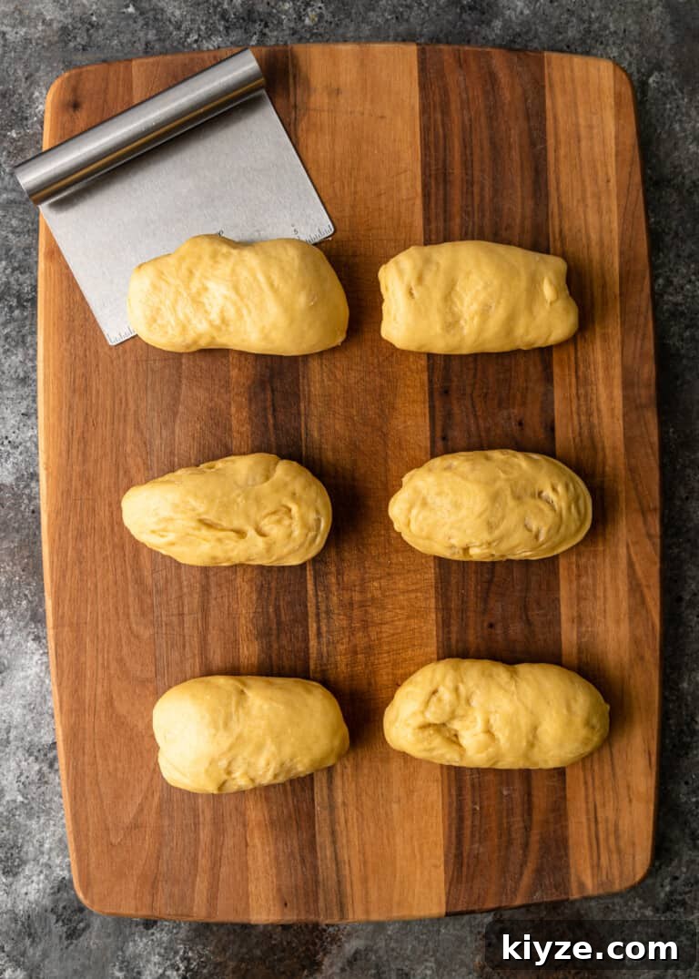 Classic Fluffy Challah Recipe for Braiding and Baking 8 dough cut into six equal pieces and shaped into rectangles on cutting board