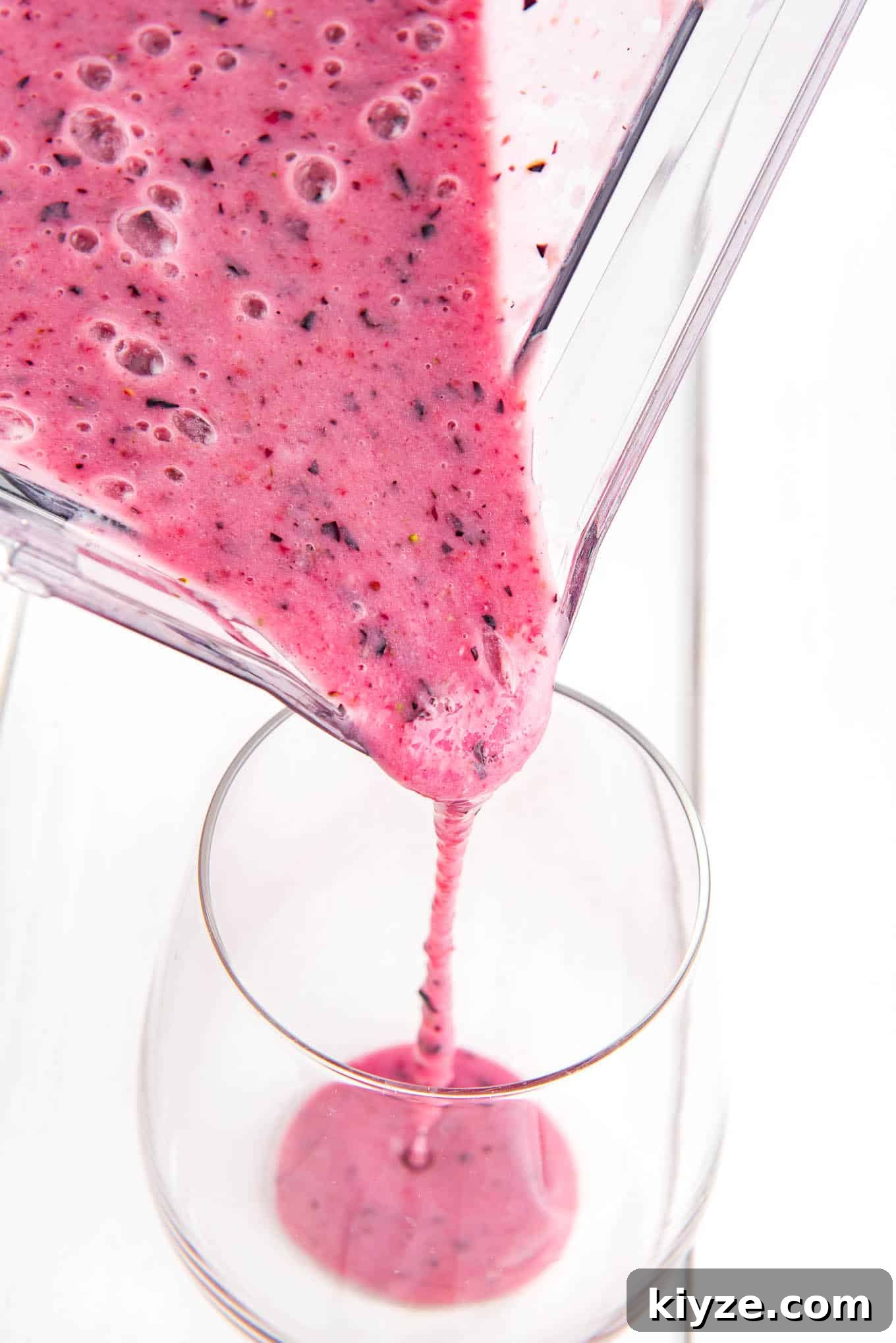 Creamy Blueberry Smoothie with Greek Yogurt 5 Pouring blueberry smoothie.