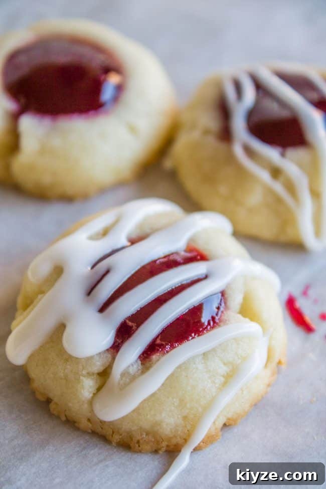 Almond Raspberry Thumbprint Cookies: Chewy Jam-Filled Recipe 5 Raspberry Shortbread Cookies with glaze drizzled on top.