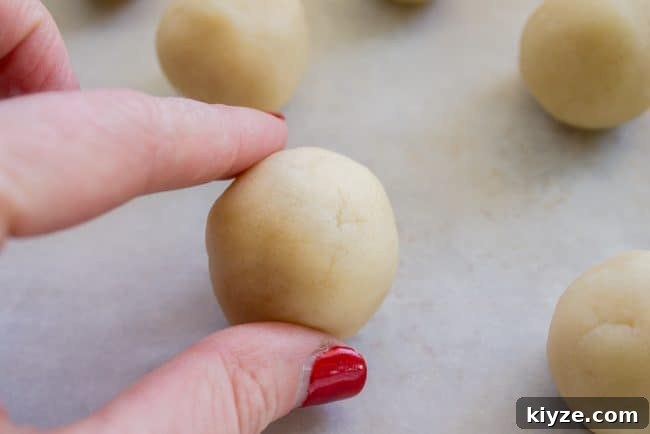 Almond Raspberry Thumbprint Cookies: Chewy Jam-Filled Recipe 7 Shortbread dough rolled into a ball.