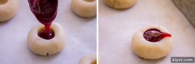 Almond Raspberry Thumbprint Cookies: Chewy Jam-Filled Recipe 10 Spooning jam into thumbprint cookie.