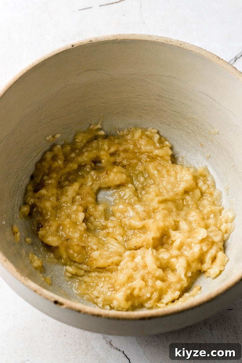 Moist Banana Bread Muffins with Chocolate Chips 4 mashed banana in a bowl