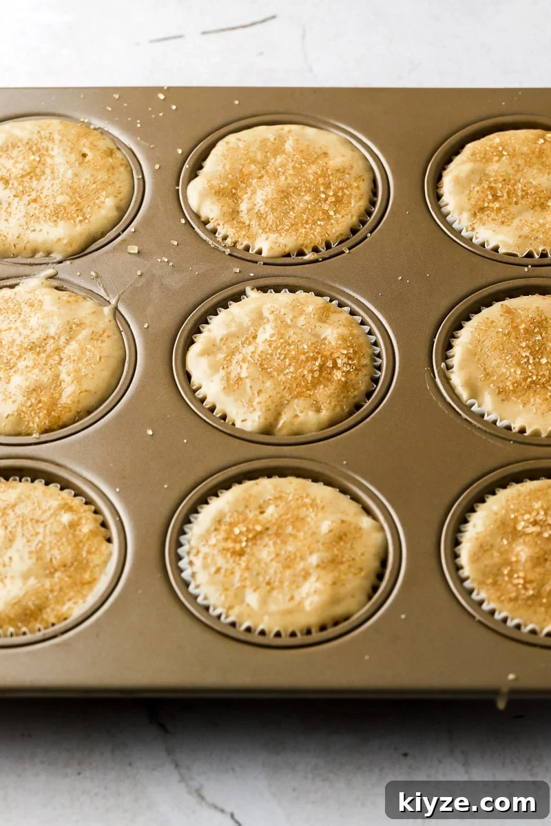 Moist Banana Bread Muffins with Chocolate Chips 7 muffin batter in muffin tins with a sprinkling of raw sugar