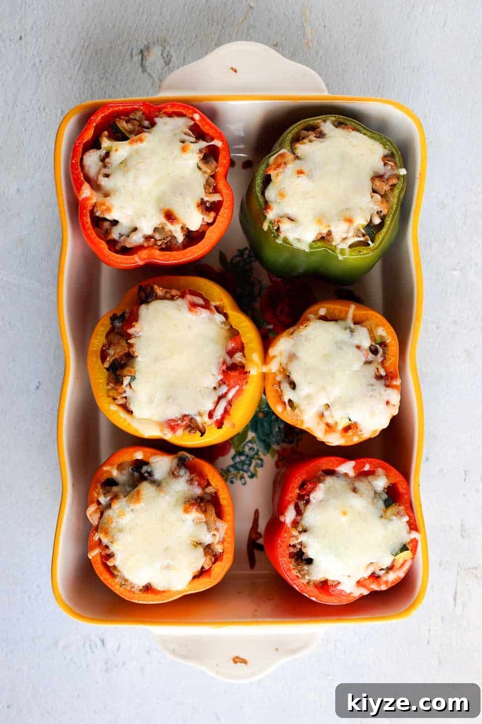 Ground Turkey and Rice Stuffed Bell Peppers Recipe 11 Baking dish with six whole stuffed bell peppers topped with melted mozzarella cheese