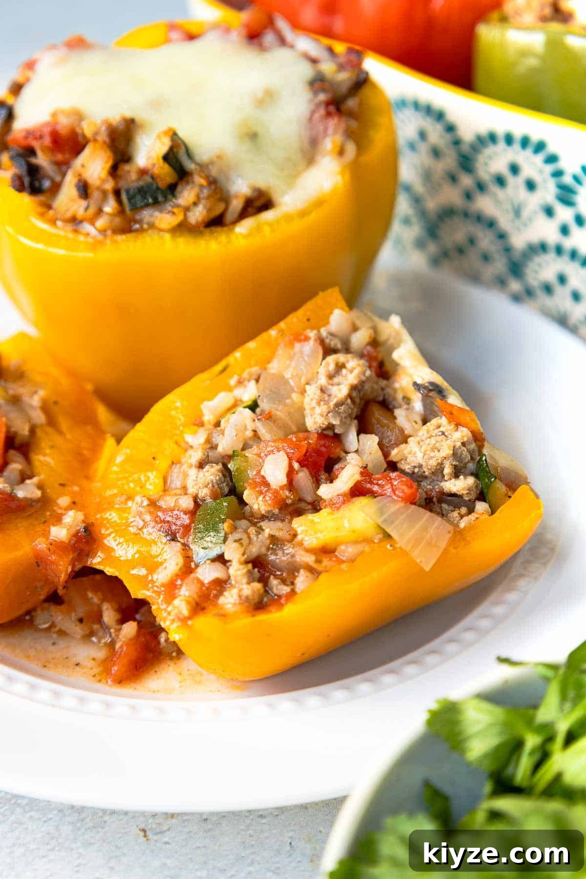 Ground Turkey and Rice Stuffed Bell Peppers Recipe 12 Stuffed yellow bell pepper cut in half to show stuffing inside of rice, ground turkey, and veggies.