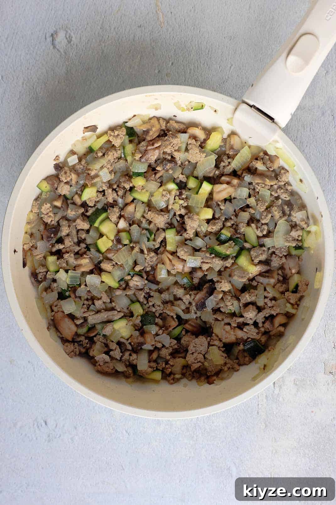Ground Turkey and Rice Stuffed Bell Peppers Recipe 6 Zucchini and mushrooms are cooked down into the ground turkey mixture in the skillet until the moisture is released.