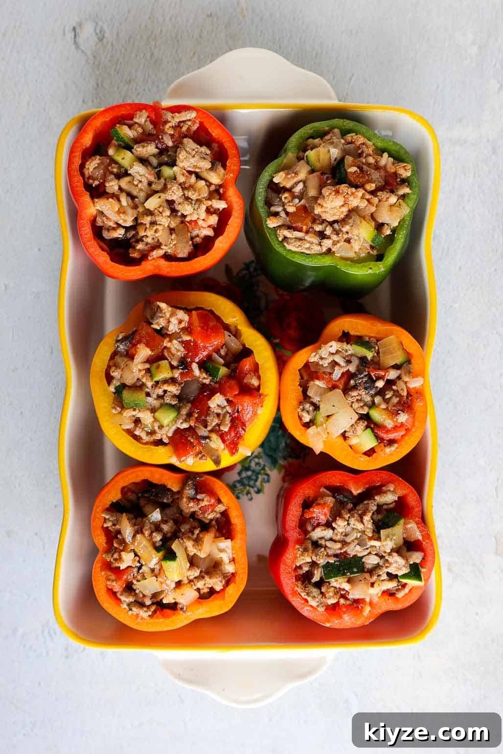 Ground Turkey and Rice Stuffed Bell Peppers Recipe 8 Baking dish with six multicolored bell peppers stuffed until full with turkey mixture.