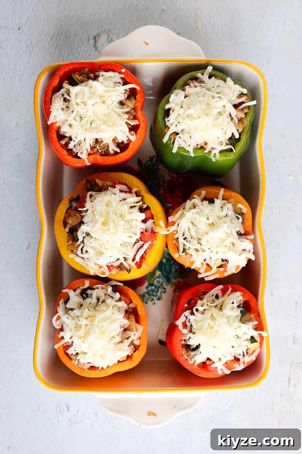 Ground Turkey and Rice Stuffed Bell Peppers Recipe 10 Baking dish with six multicolored stuffed bell peppers topped with shredded mozzarella cheese