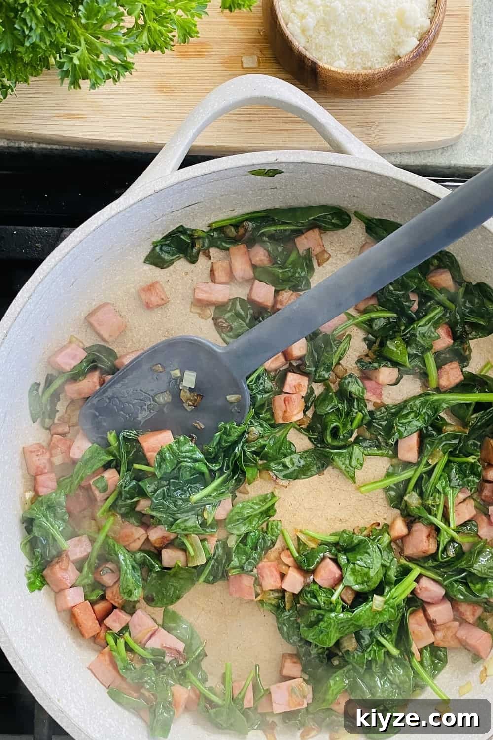 sauteing onion, ham and spinach