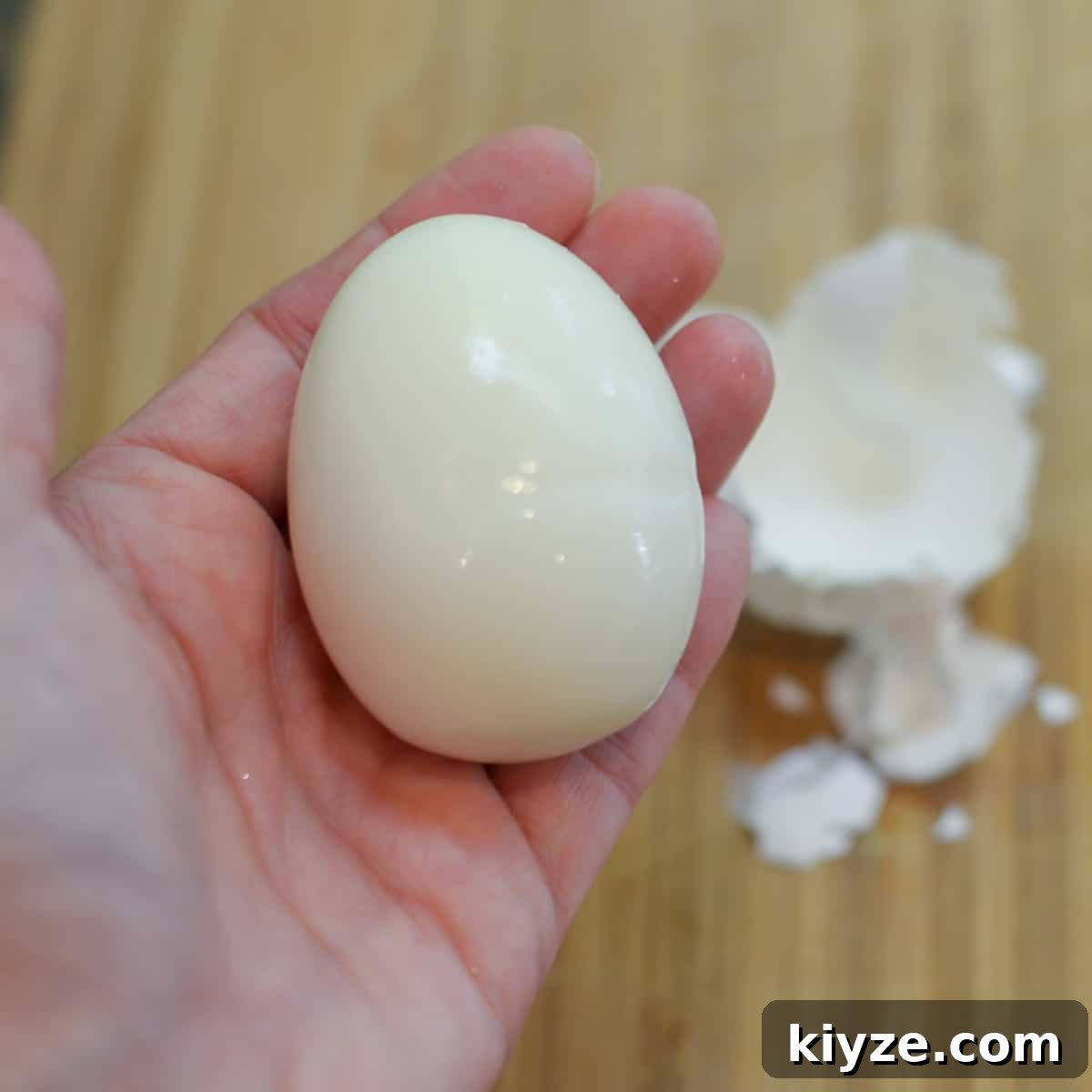 How to Make Hard-Boiled Eggs That Peel Perfectly 8 A hand holds a freshly peeled hard boiled egg.