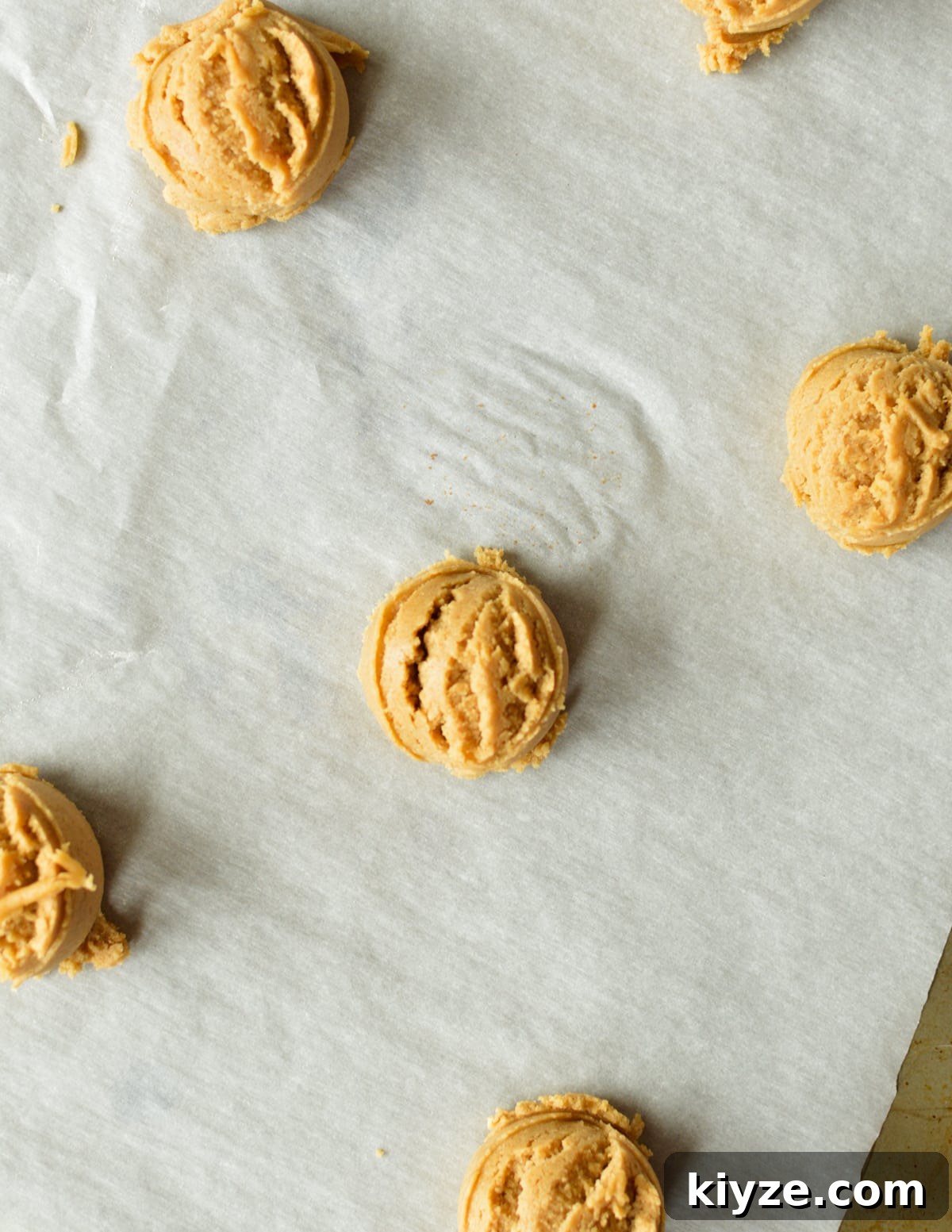 Chewy Peanut Butter Cookies Made with Oat Flour 10 peanut butter cookie dough balls on sheet pan.