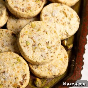 Pistachio shortbread cookies on a tray.