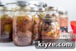 jars of canned deer with canning supplies