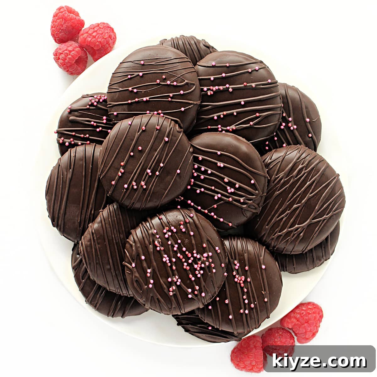 Raspberry Rally Cookies Recipe — Soft Homemade Jam-Filled Cookies 7 Choclate coated cookies on a platter.