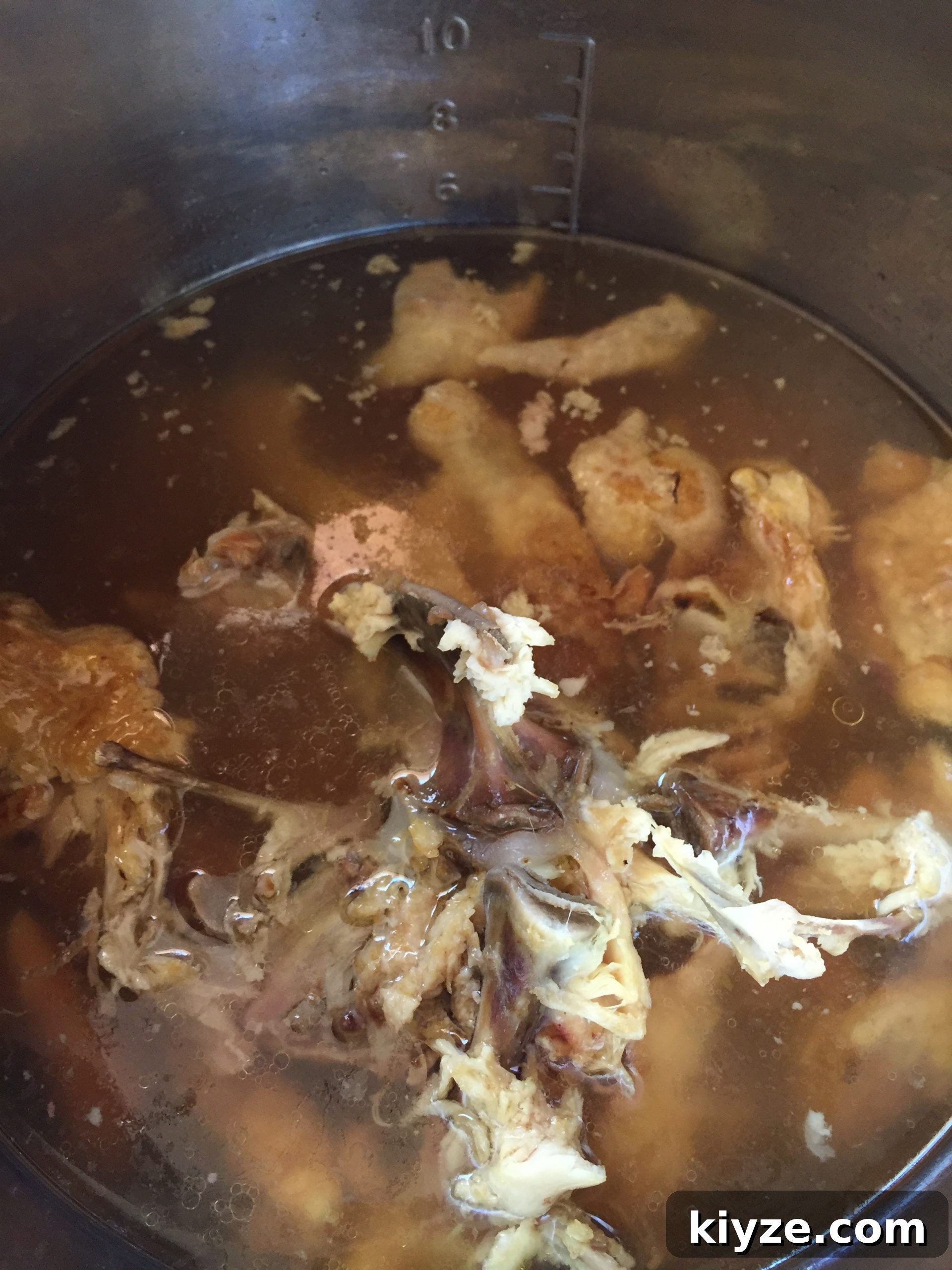 Hot cooked bone broth with a layer of oil on top