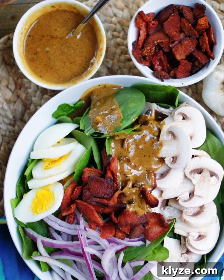 Drizzling Hot Bacon Dressing over Spinach Salad with mushrooms, red onion and boiled egg