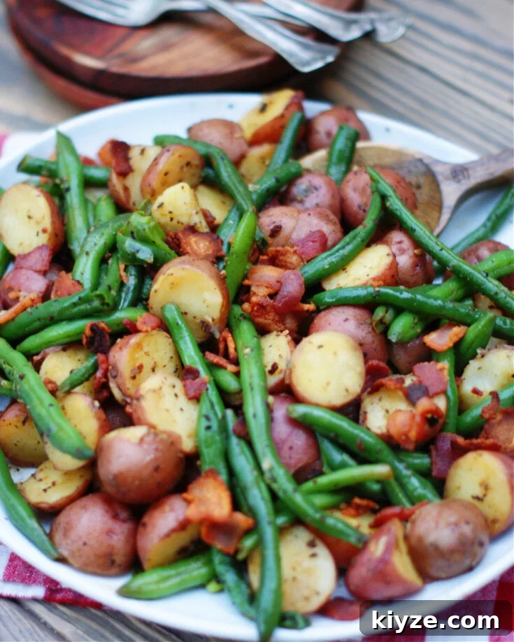 country style fresh green beans and new potatoes with crumbled bacon as a vegetable side dish