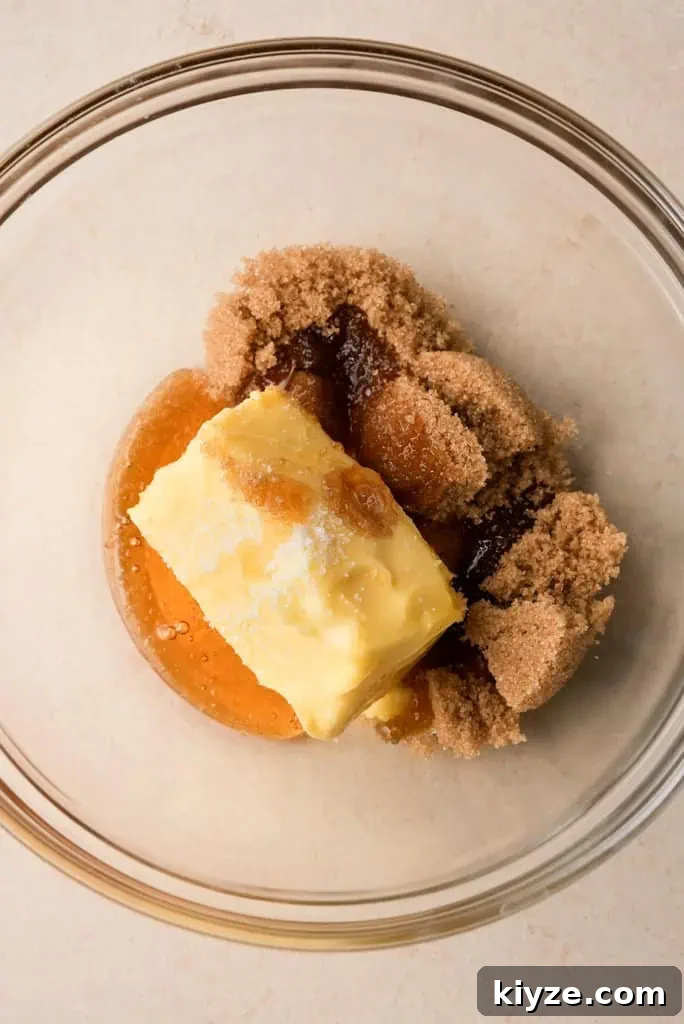 honey, butter, and sugar in a clear mixing bowl