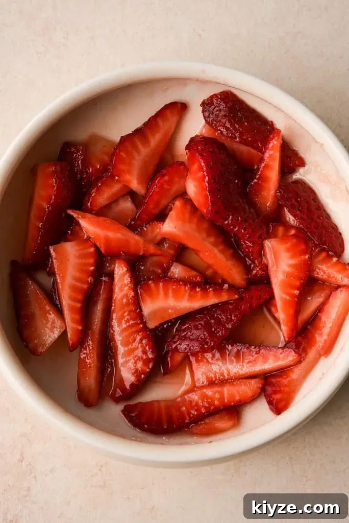 a bowl of quartered strawberries
