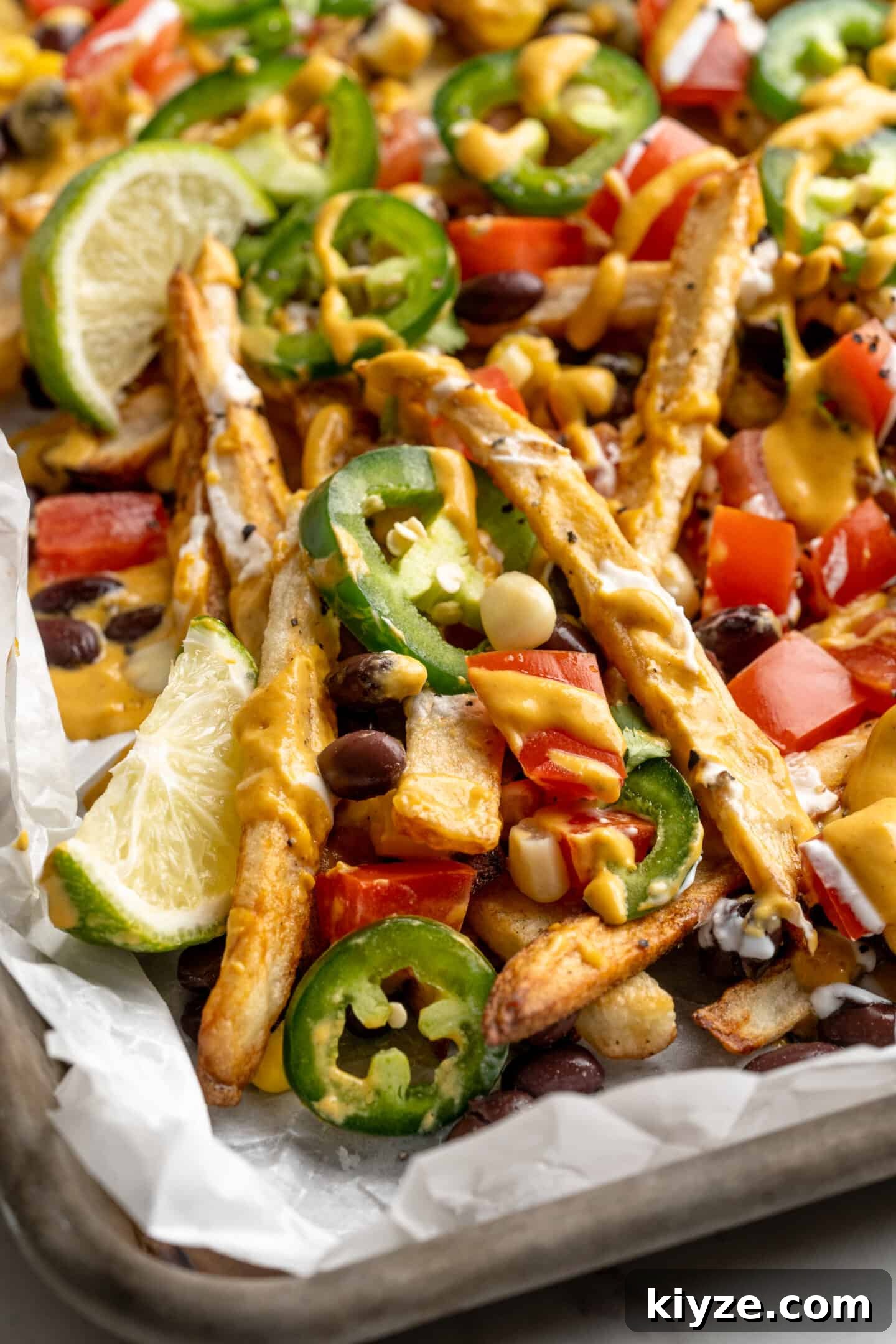 Get the party started with loaded nacho fries! They're topped with all your favourite nacho toppings to create an irresistible appetizer. Loaded nacho fries on sheet pan