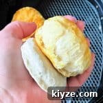 showing a frozen biscuit side by side with one cooked in the air fryer