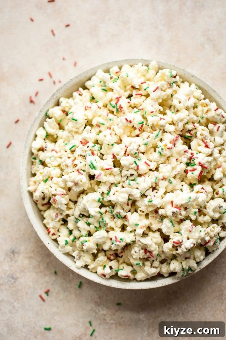 Festive Christmas Popcorn Recipe for Holiday Parties 3 bowl of white chocolate popcorn with festive sprinkles