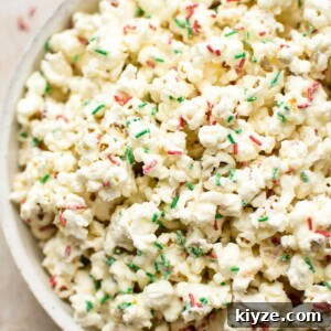 Festive Christmas Popcorn Recipe for Holiday Parties 6 This white chocolate Christmas popcorn recipe is easy and festive. Perfect for Christmas parties! You can easily portion it out into bags for kids' snacks or fun and simple homemade edible Christmas gifts.