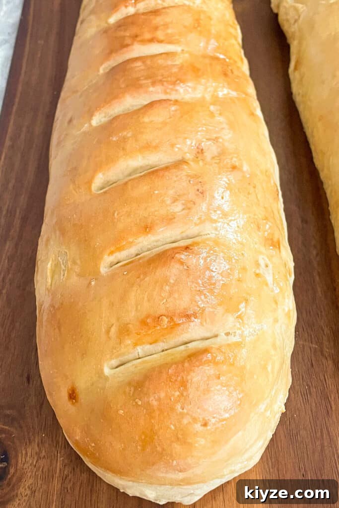 90-Minute Artisan French Bread Recipe for Crisp Crust and Soft Crumb 4 close up photo of a loaf of baked French bread on a cutting board