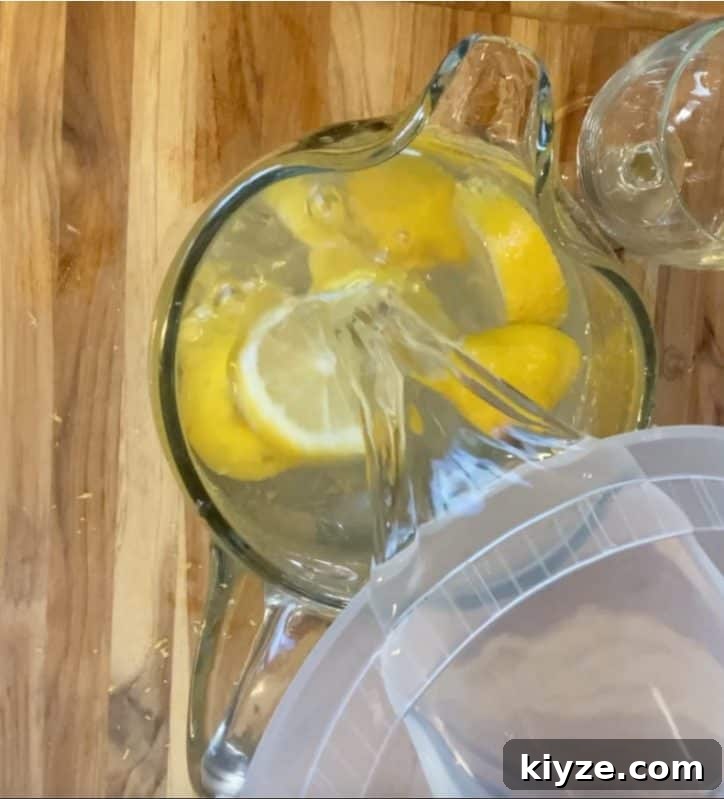 Benefits of Drinking Lemon Water Daily 8 adding water to pitcher