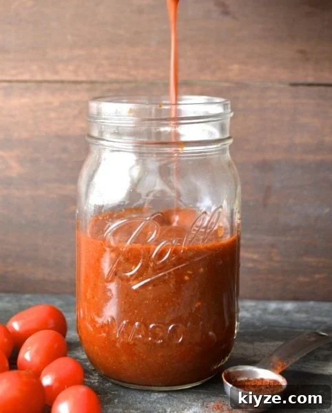 Authentic Homemade Enchilada Sauce Recipe for Rich Flavor 4 homemade enchilada sauce being drizzled into a glass ball jar